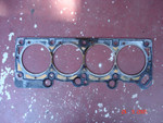 The head gasket.  Nothing obvious other than the exhaust-tinted coolant passage outlines.