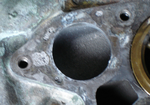 Sharpened closeup of left side of flange.  Note porous areas.