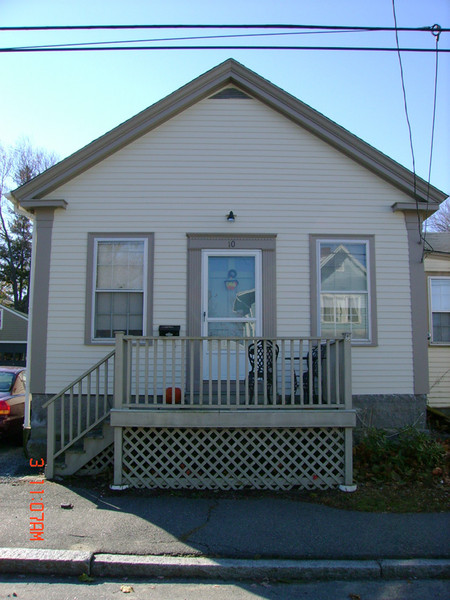 I painted the front (only) of this house in 2006, and added some flashing above the porch light to prevent water from getting into the walls.