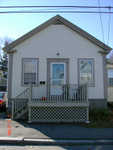 I painted the front (only) of this house in 2006, and added some flashing above the porch light to prevent water from getting into the walls.
