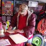 The new owner Brian signs the papers to his dream machine.