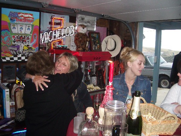 Hugs were all around at the party. Funny how good champange will do that to some people.