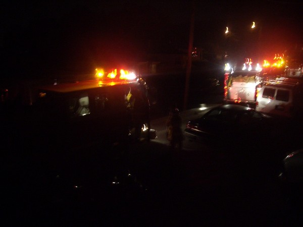 The street is filled with fire fighting trucks and equiptment.