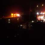 The street is filled with fire fighting trucks and equiptment.