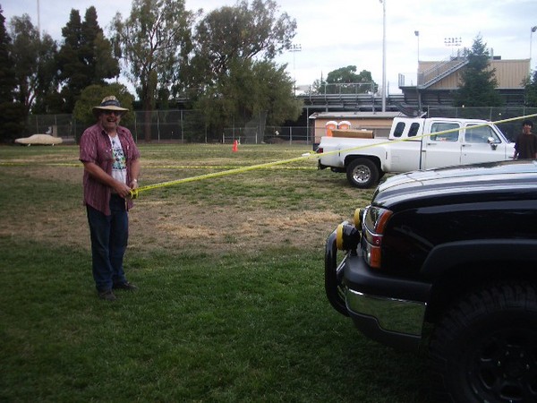 Fred ropes off the feild for the cars that will fill the place tommorow.