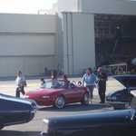 Sally conned Spinelli into waxing the Miata for her.