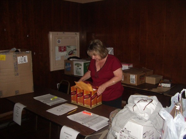 Diane Rivers gets the goodies bags and raffle prizes in place.