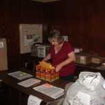 Diane Rivers gets the goodies bags and raffle prizes in place.