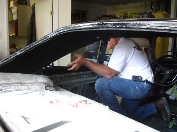 Mark installs the rear glass.