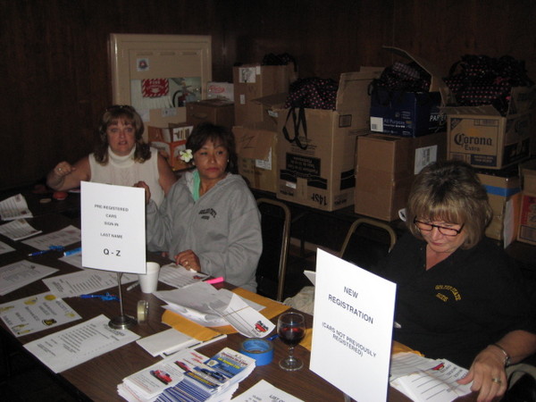 The ladies of the Golden State Rods pitch in to get us all signed in.