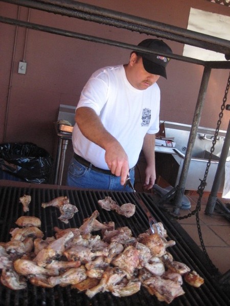 Tony pitches in to cook the chicken.