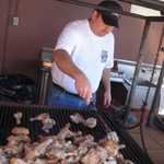 Tony pitches in to cook the chicken.