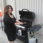 Sally cleans the grill.