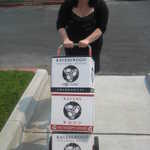 Sally hauls in the vino for our booth.