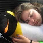 One tired girl, one useful penguin.