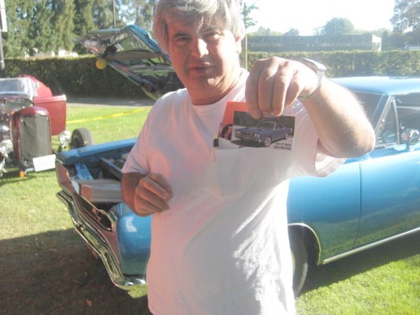 John shows us a card of his car.