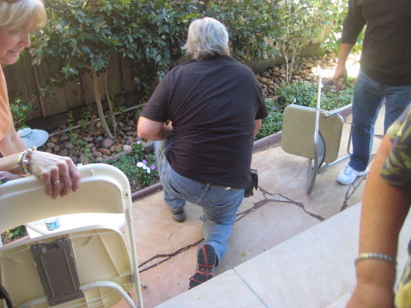 Mike tests out the thickness of the patio floor and his head at the same time.