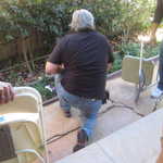 Mike tests out the thickness of the patio floor and his head at the same time.