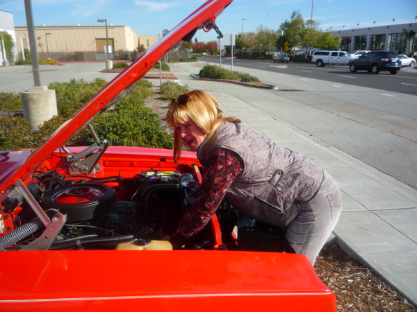 Bev does a little wrenching on her 68 charger.