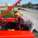 Bev does a little wrenching on her 68 charger.