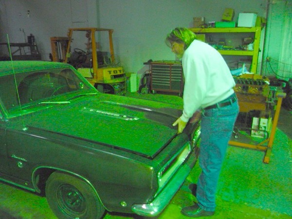 Sandy opens the bonnet to his new 68 'Cuda.