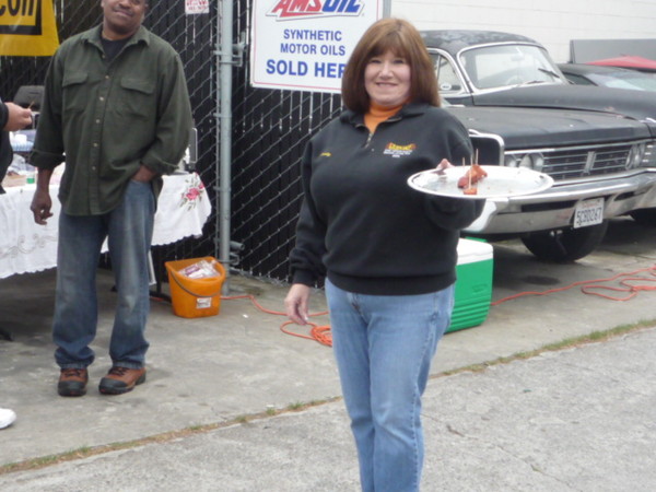 The hottest hostess with the mostest passes out some hot sausages. Say that 10 times fast!