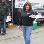 The hottest hostess with the mostest passes out some hot sausages. Say that 10 times fast!