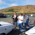 Sandy shows Mike the fine art of opening and chugging an Alexander Keiths.