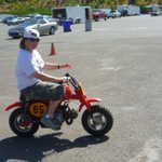 Miss Evil Kenevil tries out Jim Garcia's minibike.