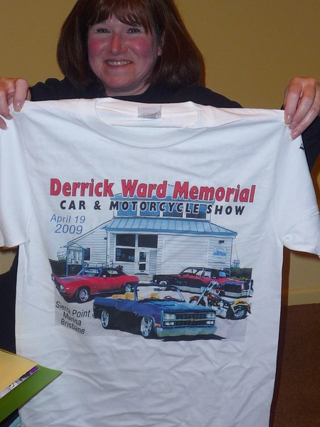 Cindy holds up the 2009 Derrick Ward Memorial car show T-shirt