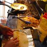 We mass produce a whole mess of carnitas breakfest burritos.