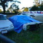 We sneak across the road to see what's under the tarp??