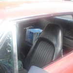 Notice the caes of oil in the back seat!