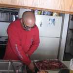 Steve starts getting the ribs ready for dinner.