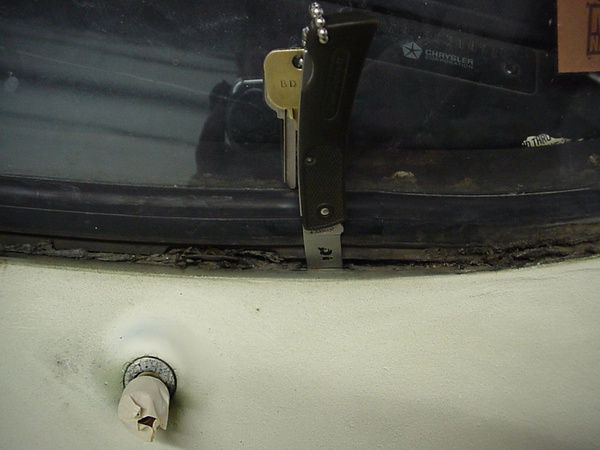 Windshield Lower Left Drain-hole!
Pocket knife to show location.