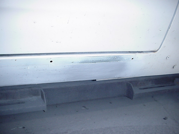 Driver Side shows silver paint along
the rocker!